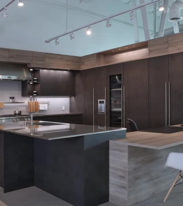 Tall smoked-timber units and an illuminated niche in the showroom
